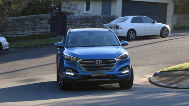 A 2017 Hyundai Tucson in Ara Blue cornering in Australia