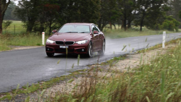 2018 BMW 440i Gran Coupe Review Aventurine Red Driving Front Three Quarter