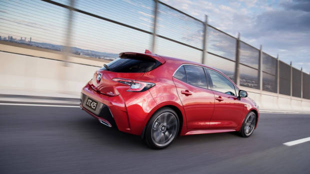 2019 Toyota Corolla ZR hybrid Volcanic Red rear 3/4 driving