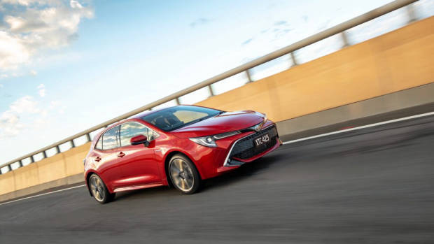 2019 Toyota Corolla ZR hybrid Volcanic Red side 3/4 driving