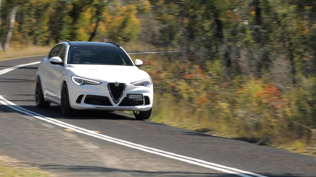 2021 Alfa Romeo Stelvio Quadrifoglio SUV white exterior front 3/4 driving shot 2