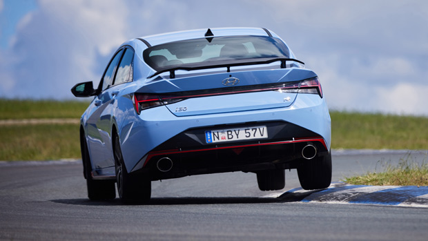 2021 Hyundai i30 Sedan N blue sedan exterior rear 3/4 action shot Wakefield Park 1