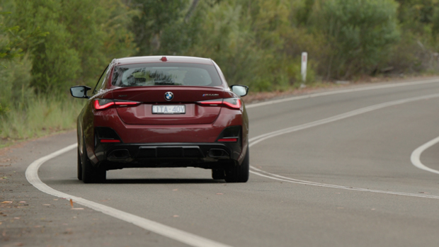 2022 BMW M440i sedan purple - dynamic rear 3/4 shot