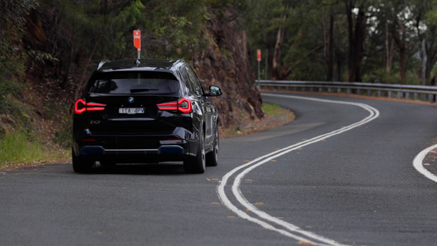 2022 BMW iX3 M Sport black action shot road