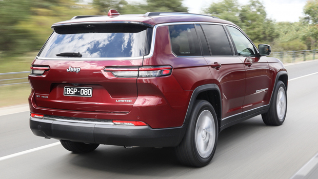 2022 Jeep Grand Cherokee Limited SUV red - rear 3/4 driving shot #1