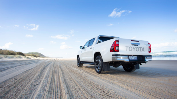 2022 Toyota Hilux SR5 review white ute - static rear 3/4 beach pic #1