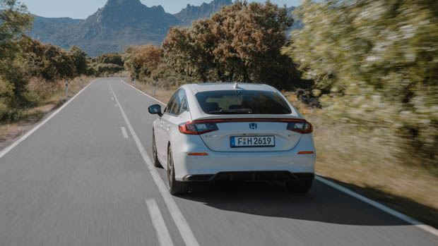 Honda Civic e-HEV 2023 on road driving rear