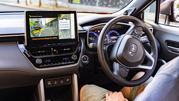 2023 Toyota Corolla Atmos Hybrid AWD wagon red interior driving position