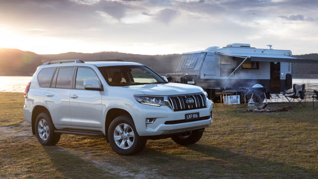 Toyota Prado front 3/4 with caravan in the background