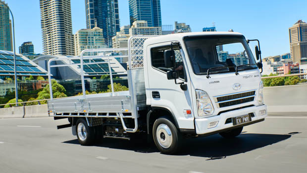 2023 Hyundai Mighty truck front 3/4 city background
