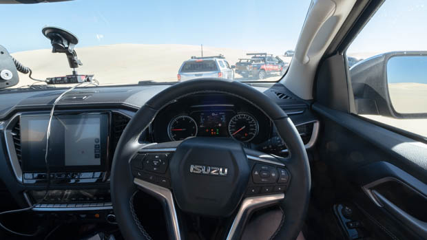 Isuzu stockton beach behind the wheel with dunes in background