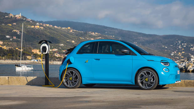 2023 Abarth 500e Turismo blue charging by the water