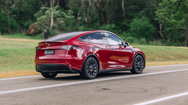 2023 Tesla Model Y Performance red side driving