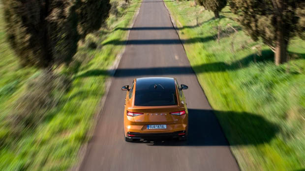 2022 Skoda Enyaq Coupe iV rear shot driving down road high angle