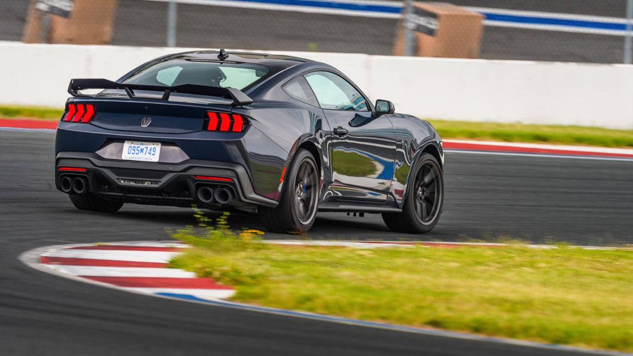 Ford Mustang Dark Horse 2024 driving rear 3/4 3