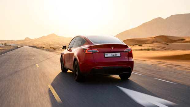 2023 Tesla Model Y red rear 3/4 desert