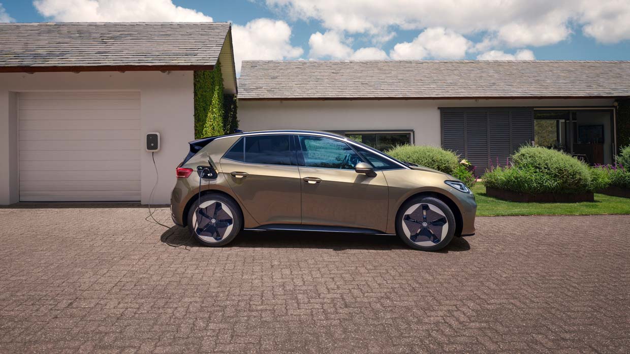 Side profile view of a 2024 Volkswagen ID3 Pro S in dark olivine green charging