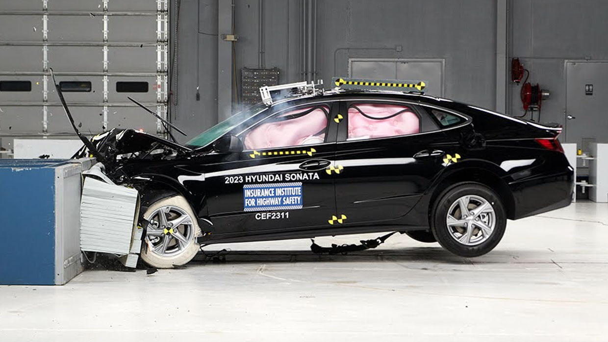 Side profile action shot of the IIHS full frontal crash test of the 2023 Hyundai Sonata sedan