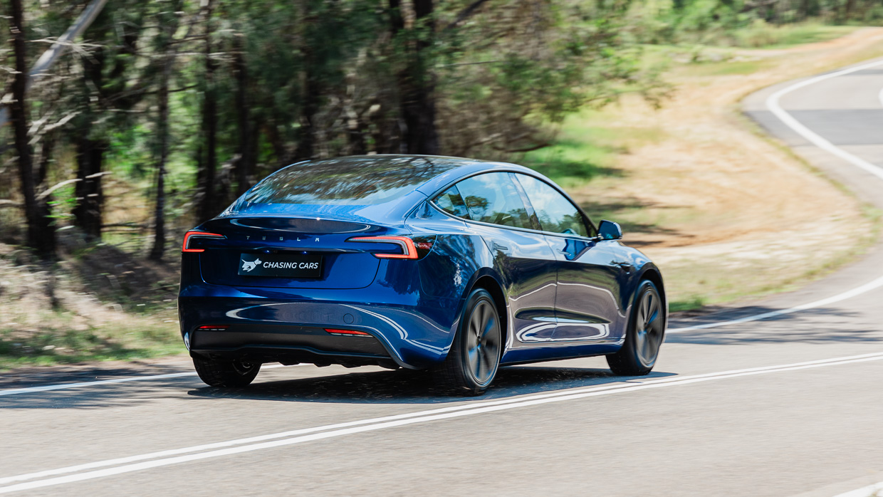 Tesla Model 3 RWD 2024 driving rear 3/4 2