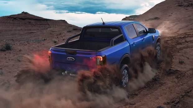 2024 Ford Ranger XLT driving in dirt rear 3/4