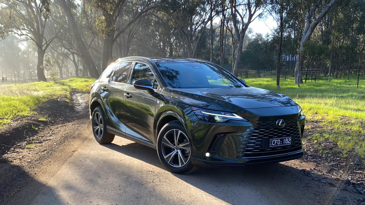 2023 Lexus RX350h long termer front 3/4 with trees in background 2