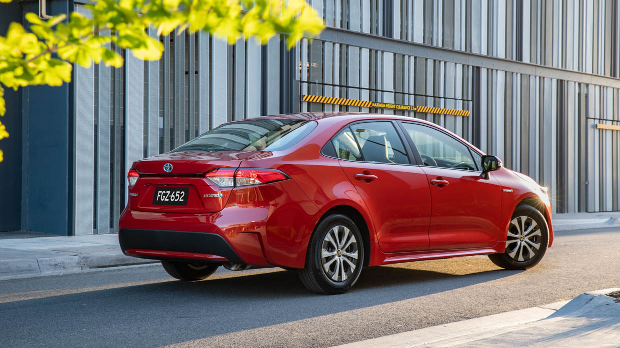 2020 Toyota Corolla Ascent Sport hybrid orange rear 3/4 static