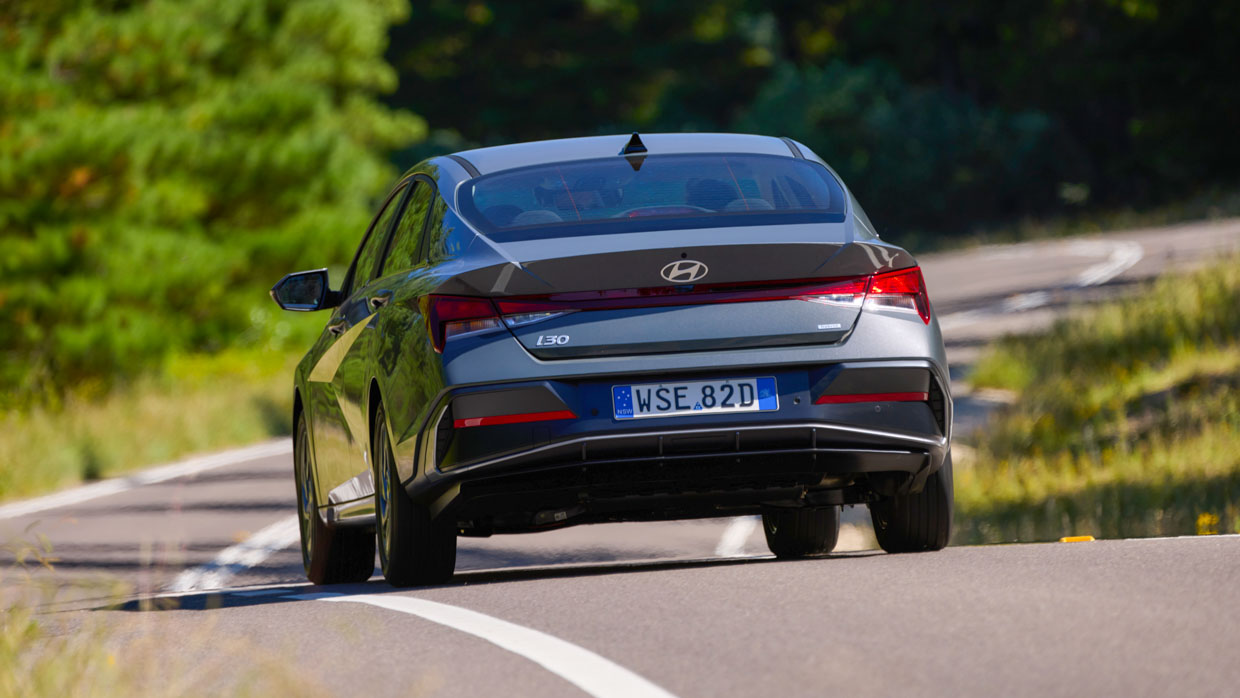 Hyundai i30 Sedan hybrid 2024 driving rear 2