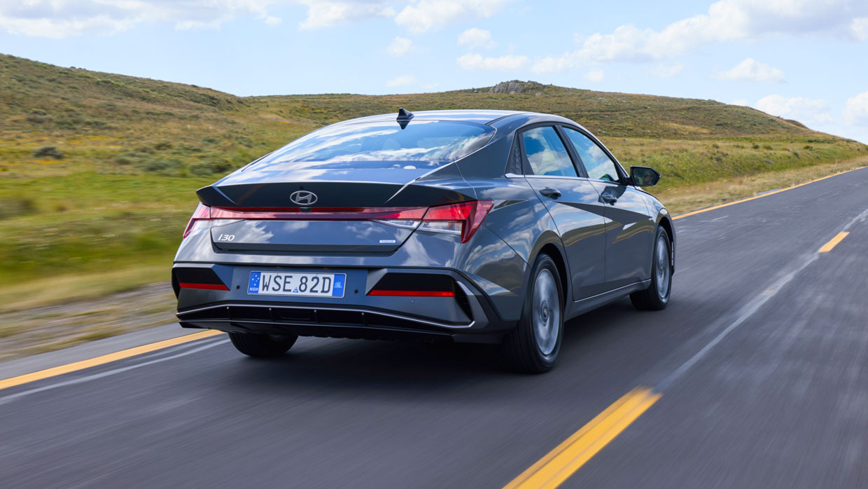 Hyundai i30 Sedan hybrid 2024 rear 3/4 driving