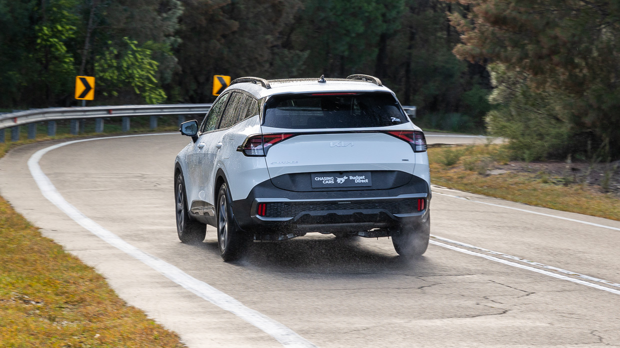 2024 Kia Sportage GT-Line Hybrid LT driving rear 3/4
