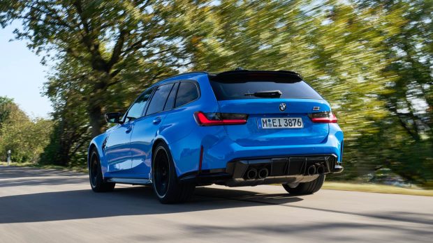 2024 BMW M3 Touring blue rear 3/4 driving shot