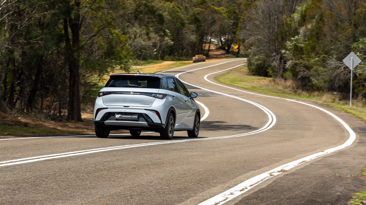 2024 BYD Dolphin Premium rear angle driving shot wide