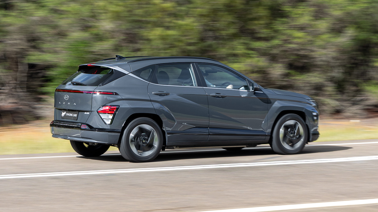 Hyundai Kona Electric 2024 driving rear 3/4 2
