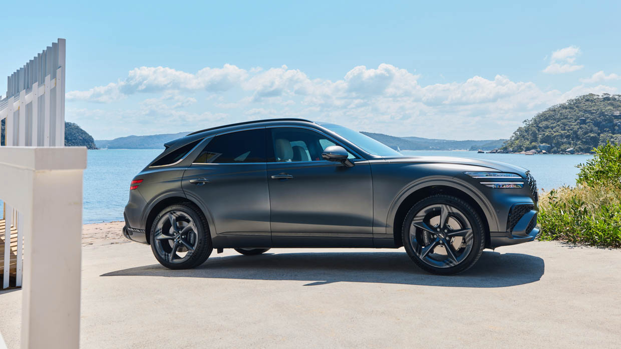 2025 Genesis GV70 Signature Sport side angle static by the water
