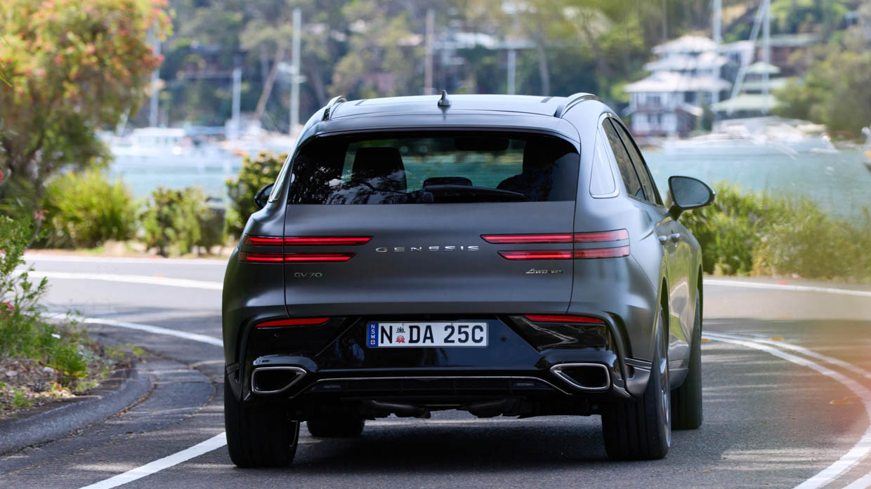 2025 Genesis GV70 Signature Sport rear angle driving shot